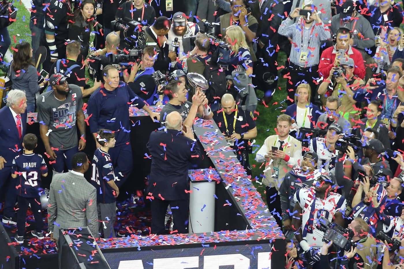 A champion lifting the Vince Lombardi Trophy